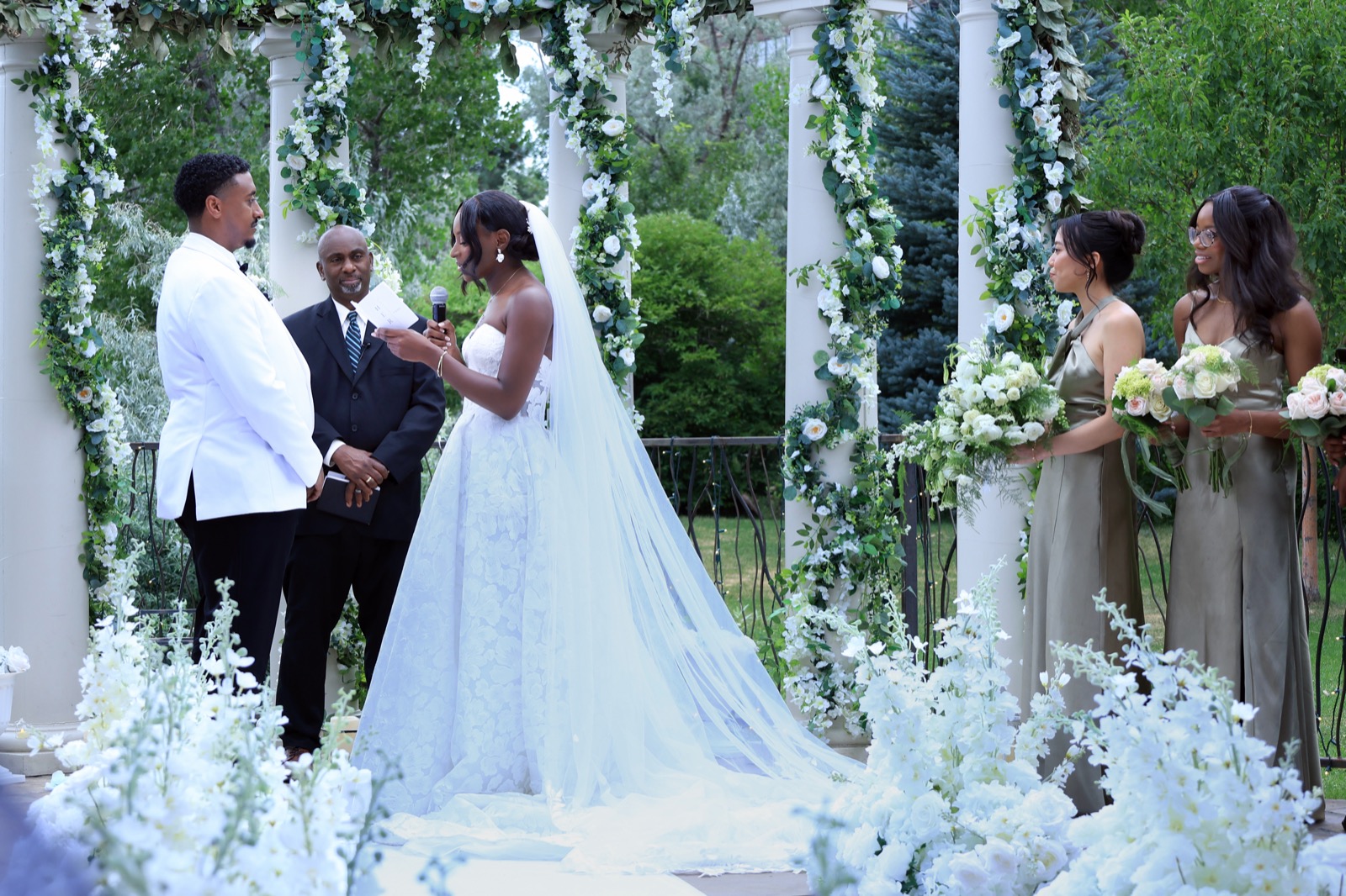Wedding ceremony under floral arch